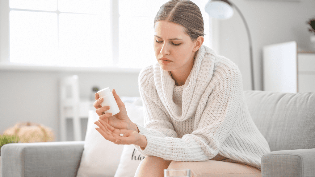 addiction (1) Upset woman taking prescription medication